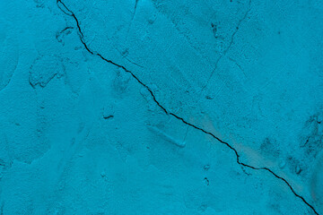 Obraz premium Crack on old dirty blue paint concrete wall of cement surface broken background damage texture