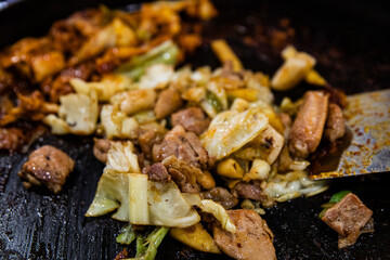 Stir-fried chicken ribs with chicken, cabbage, vegetables, spicy seasoning, and tteokbokki, traditional Korean food
