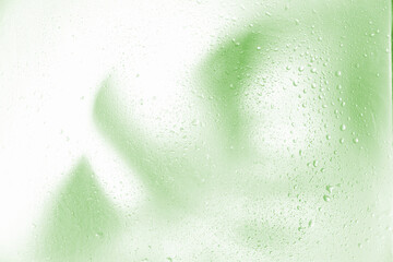 foggy background, blurry monstera leaf in white pair, water drops on glass. fog effect of palm...