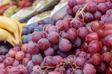 Bunches of juicy red grapes on counter.