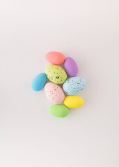 Styrofoam eggs of various colors on white background.
