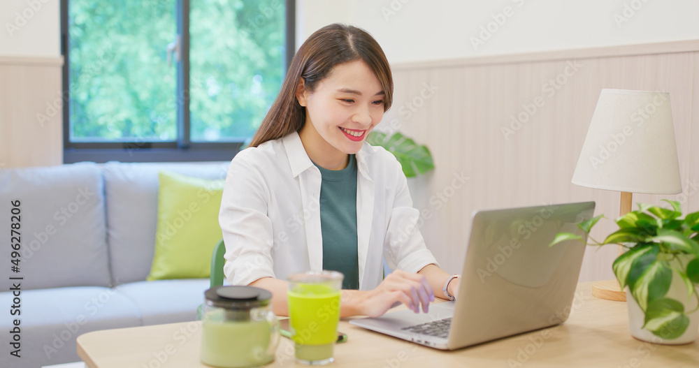 Poster woman using laptop at home