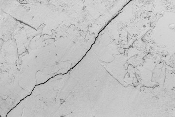 Crack on old dirty white concrete wall of cement surface broken background damage cracked texture