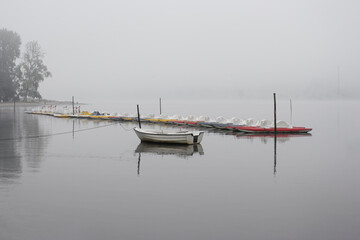 Fototapeta na wymiar Pleasure boats in a misty lake