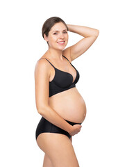 Young pregnant woman in black swimsuit. Girl expecting a baby and touching her belly isolated on white background.