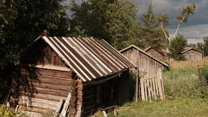 Beautiful rustic summer landscape. Old wooden log houses. Vologda region