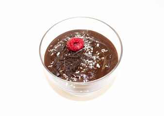 Chocolate mousse with raspberries and coconut on white background.