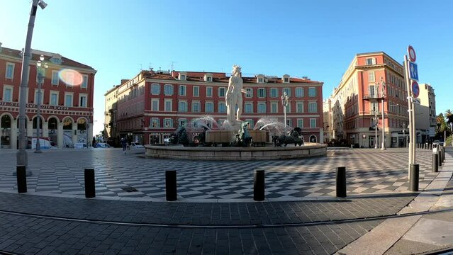 Nice, France, October 6, 2021:  Fontaine du Soleil, the Sun Fountain in Place Massena. This fountain features a statue of Apollo, who symbolizes the sun, along with bronze statues that denote planets.