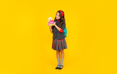 back to school. knowledge day. concept of education. kid in uniform on yellow background.