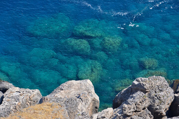 coastline with rocks and blue sea, view from top