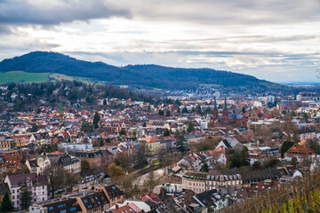 Fototapeta premium Germany, Freiburg im Breisgau city houses downtown, view above the skyline of the medieval town, streets and churches with sun