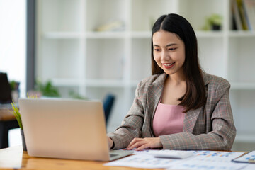 Asian business women using notebook and smiling happy for working