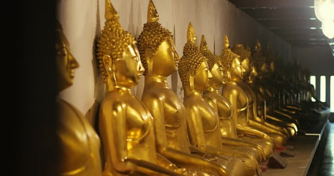 The row of Golden Buddha statues in Wat Phra Sri Rattana Mahathat Woramahawihan, Phitsanulok, Thailand.