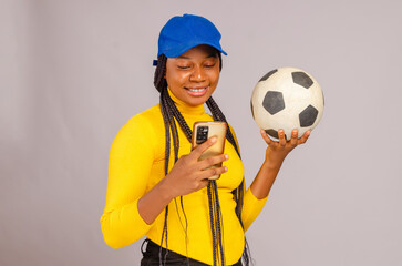 Young beautiful lady making sport bets online using mobile application.