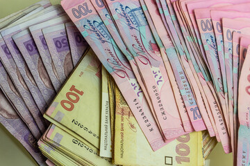 Paper money different denominations, Ukrainian hryvnia in denominations 50,100, 200 hryvnias, new money, background with scattered banknotes