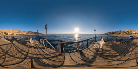 full seamless spherical hdr 360 panorama view on coast of sea with wooden pier and sun loungers by...