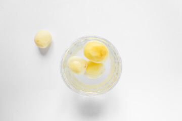 Top view of raw peeled potato vegetables in glass bowl of water. Isolated on white background.