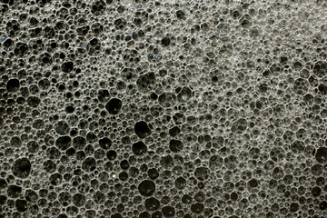 Soap foam on the surface of the water close-up