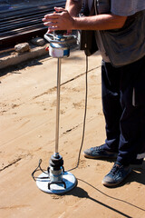 A transport engineering instrument, a lightweight deflectometer in use at onstruction site - 496286053