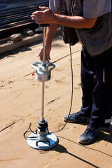 A transport engineering instrument, a lightweight deflectometer in use at onstruction sight - 496286058