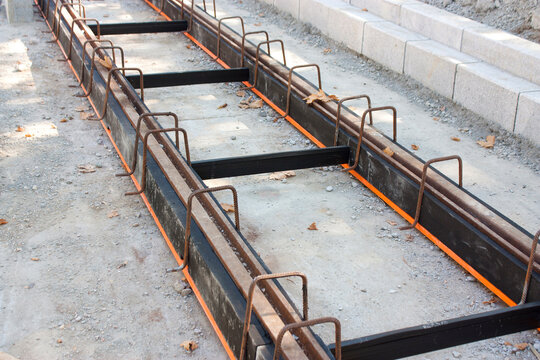Tramway tracks with damping material coating
