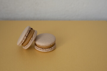 Two macaroons on a yellow background. The sweet dessert is isolated.