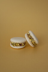 Two macaroons on a yellow background. The sweet dessert is isolated.