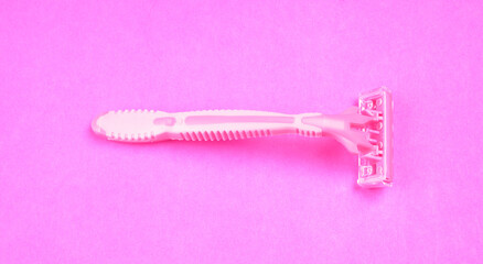 New pink disposable razors for safe shaving of female skin.Razor for smooth shaving. Sharp razors for personal hygienic routine. selective focus.

