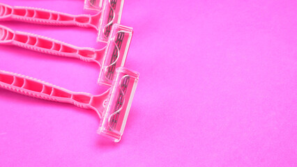 New pink disposable razors for safe shaving of female skin.Razor for smooth shaving. Sharp razors for personal hygienic routine. selective focus.
