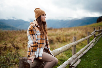 Fototapeta na wymiar Pleasant brunette enjoying fresh mountain air