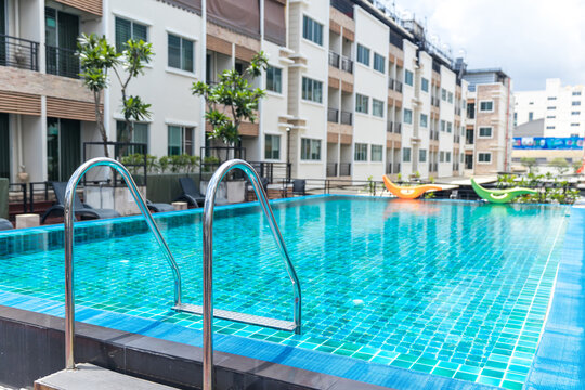 dder stainless handrails for descent into swimming pool. Swimming pool with handrail . Ladder of a swimming pool. Horizontal shot. stairs swimming pool. Stainless steel ladder