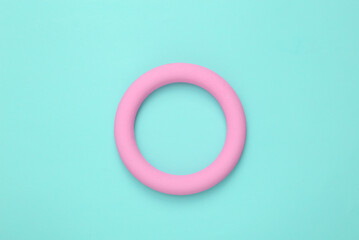 Pink ring on a turquoise background. Minimal still life. flat lay. Mock up