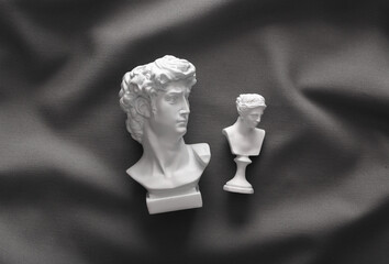 David and Venus plaster bust on gray crumpled silk background © splitov27
