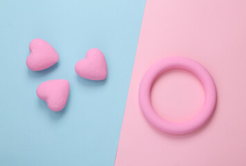 Pink ring and hearts on pink blue background. Love concept. Top view