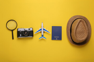 Flat lay composition with travel accessories and attributes on a yellow background. Tourism. Top...