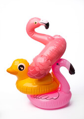 Inflatable pink flamingo and duck isolated on white background