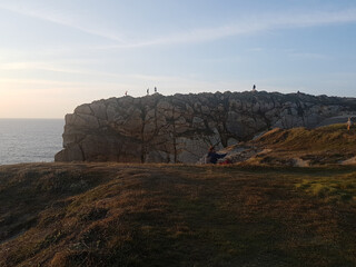 Many people in the top of the cliff