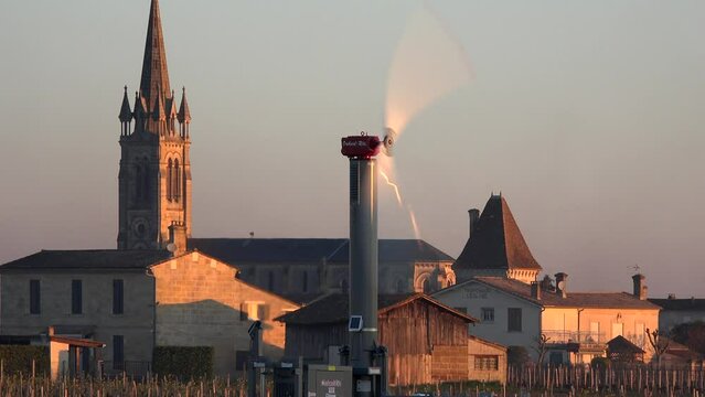 FRANCE, GIRONDE, POMEROL, WIND TURBINES ARE USED AS AIR STIRRERS IN VINEYARD DURING SUB-ZERO TEMPERATURES OF MARS 2021, BORDEAUX VINEYARD. High quality 4k footage