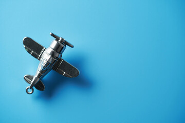 metal toy airplane against blue background  top view