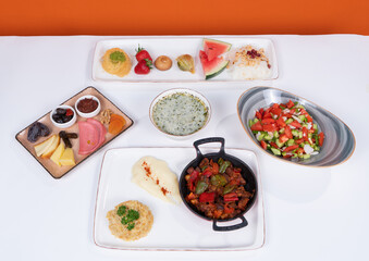 Image of dessert plate, salad, garnish, plateau soup, and meat hair pans in white-orange background in isolated environment.