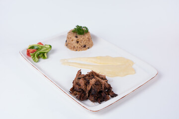 Image of meat tandoori, mashed potatoes, salad and bulgur pilaf shot from opposite or side angle on isolated white background.