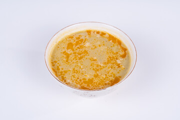 Cropped view of lentil soup shot from opposite or side view on isolated white background.