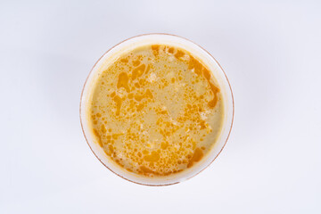 Cropped view of lentil soup shot from an overhead angle on an isolated white background.