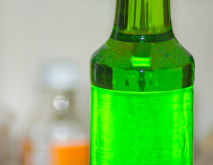a bottle of melon flavored green syrup in the room. Drinks that are suitable for the month of Ramadan. Selective focus, detailed