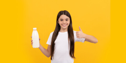 cheerful child hold dairy beverage product. teen girl going to drink milk