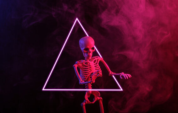Skeleton in dense smoke, triangle with red blue neon light. Scary, Halloween theme