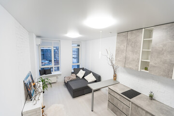 Small studio apartment interior with kitchen area and rope screen