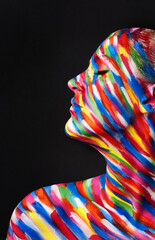 Theres no beauty without color. Studio shot of a young woman posing with brightly colored paint on...