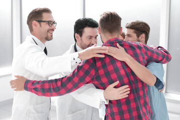 Merry cheerful doctors standing together