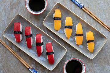 Vegan sushi nigiri - golden tomato instead of salmon and red pepper instead of tuna with soy sauce...